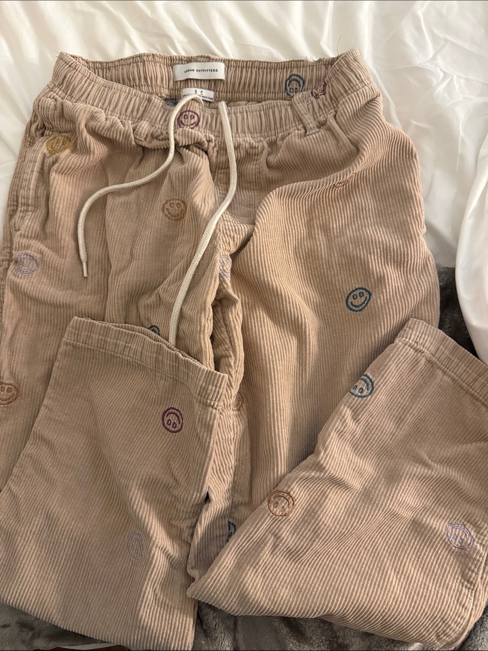 Urban OutfittersCorduroy Drawstring Pants in Tan with Embroidered Smiley Details